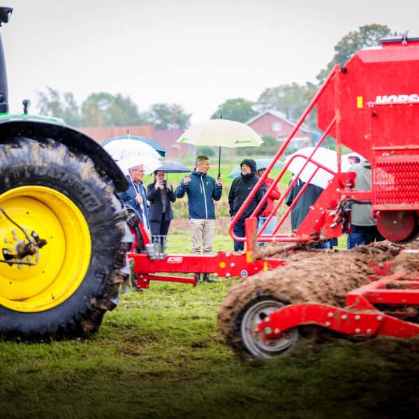 people behind land machines in rain